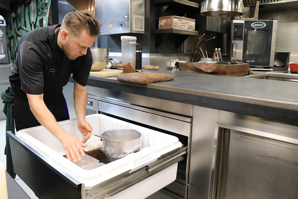 chef with hands inside adande drawer